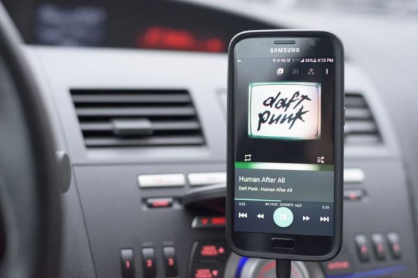 Black phone on a car phone holder.