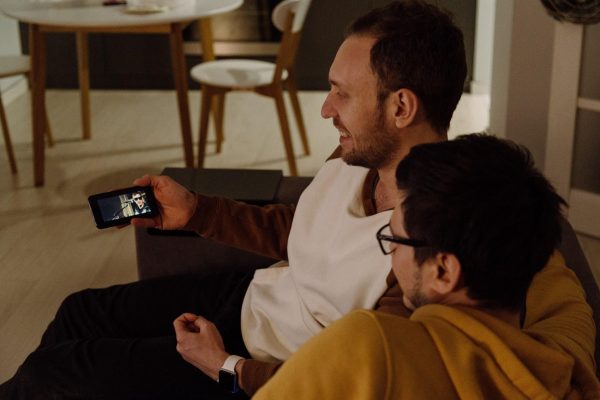 How to download movies on Hulu and Two men watching a movie on a mobile phone