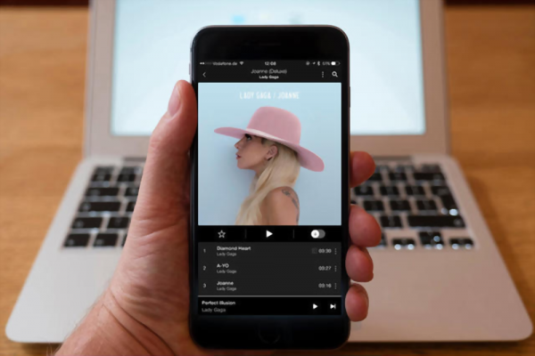 Using iPhone smartphone to display Tidal music streaming service with Lady GaGa album playing