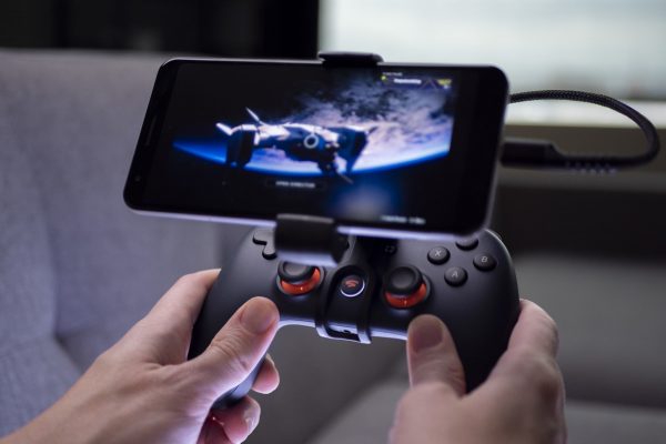 Playing games on a mobile phone with Google Stadia.