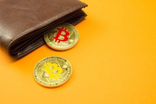 Bitcoin and Wallet on Yellow Backdrop