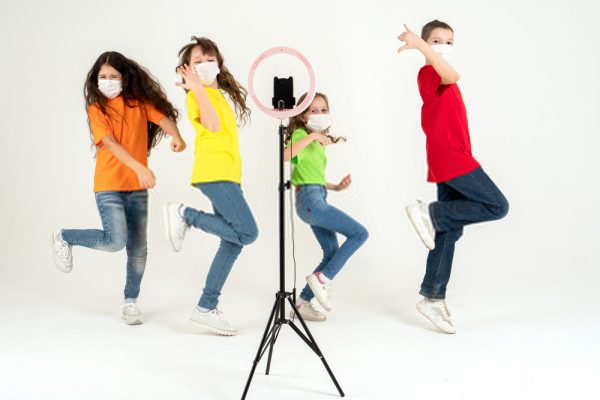 children dance in front of a camera