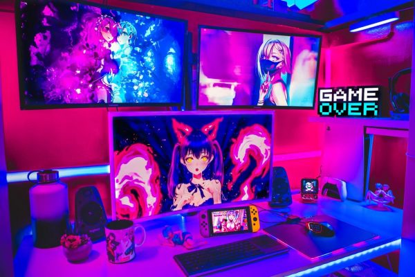 Nintendo Switch device on top of a white table in a colorful anime-themed gaming station