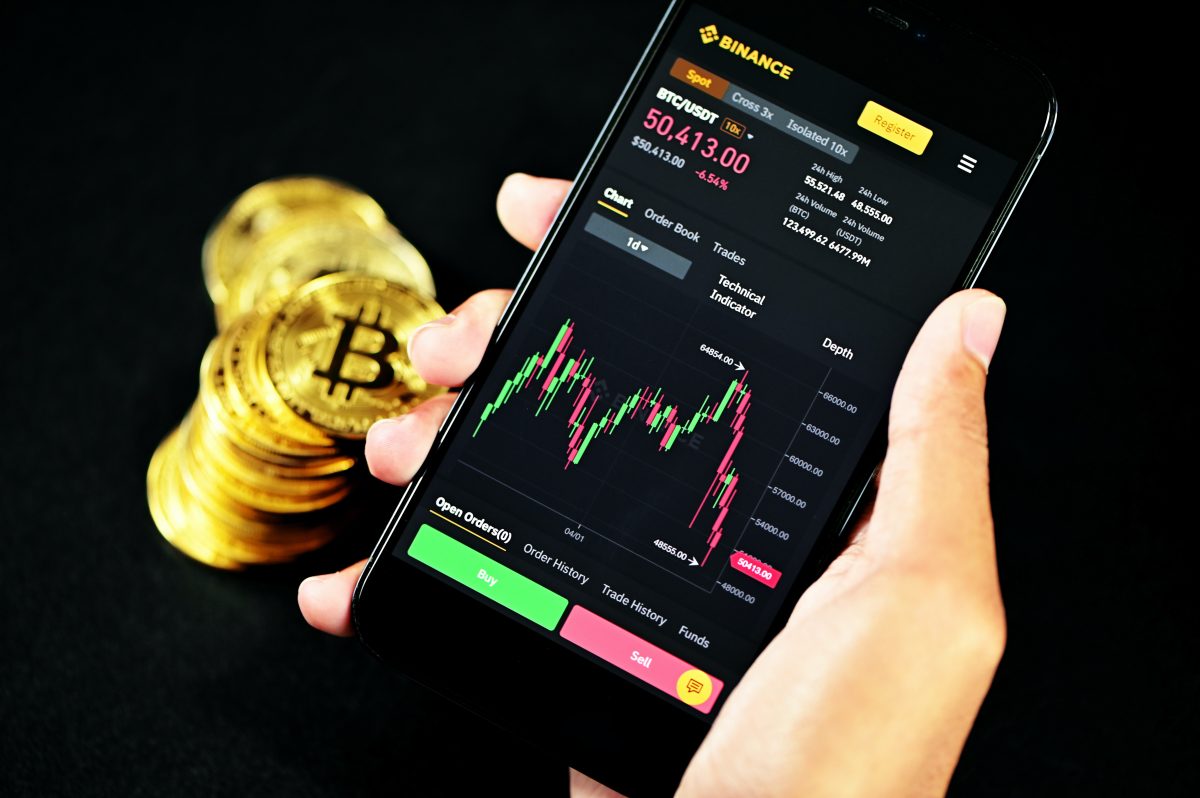 A person trading crypto on Binance using a mobile phone.