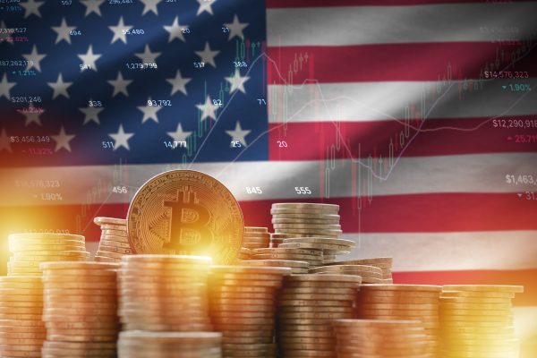 United States of America flag and big amount of golden bitcoin coins and trading platform chart
