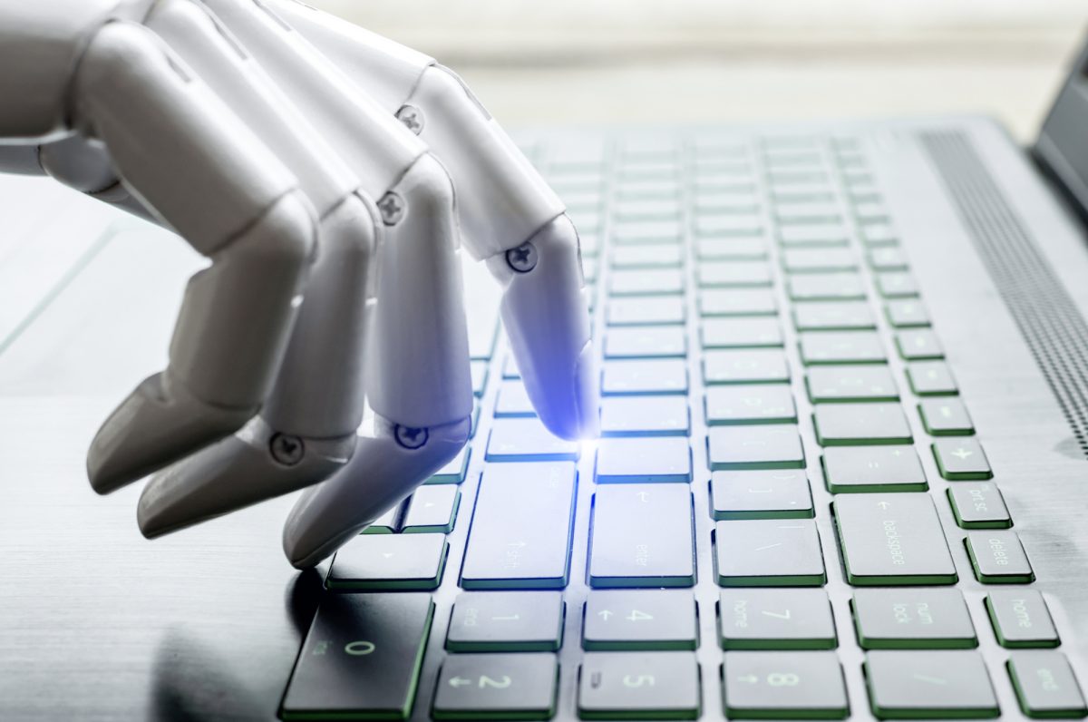 Robot hand pressing computer keyboard